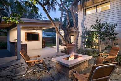Patio - transitional stone patio idea in Miami with a fire pit and no cover