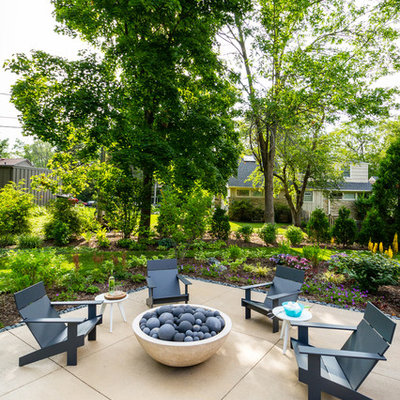 Example of a mid-sized trendy backyard concrete patio design in Milwaukee with a fire pit