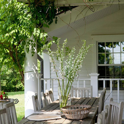 Inspiration for a timeless side yard patio remodel in New York with a pergola