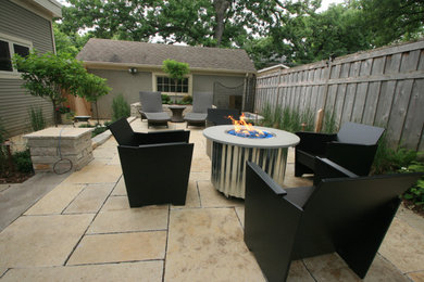 Patio - small mediterranean courtyard stone patio idea in Minneapolis with a fire pit and a pergola
