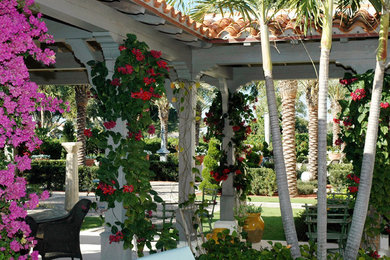 Imagen de patio mediterráneo de tamaño medio en patio trasero con adoquines de hormigón y pérgola