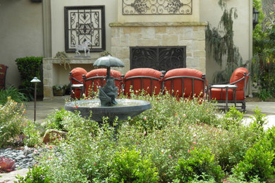 Patio fountain - large mediterranean backyard stone patio fountain idea in San Diego with no cover