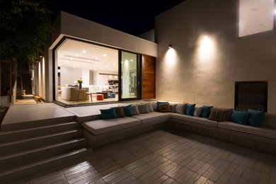 Mid-sized trendy front yard concrete paver patio photo in Los Angeles with no cover