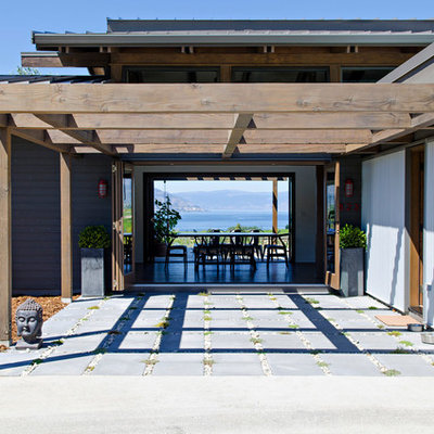 Patio - mid-sized contemporary backyard concrete paver patio idea in Vancouver with a pergola