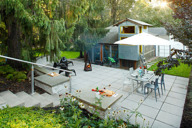Trendy backyard concrete paver patio photo in Minneapolis with a fire pit and no cover