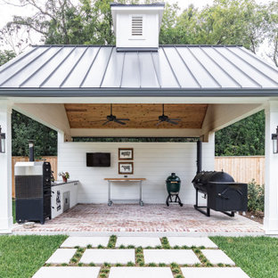 Inspiration for a mid-sized country backyard brick patio kitchen remodel in Houston with a gazebo