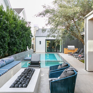 Inspiration for a contemporary backyard tile patio remodel in Orange County with a fire pit