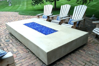 Inspiration for a modern backyard brick patio remodel in Omaha with a fire pit and no cover