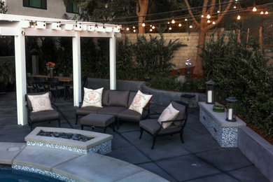 Inspiration for a small modern backyard concrete patio remodel in San Francisco with a fire pit and a pergola