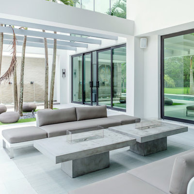 Example of a trendy patio design in Miami with a pergola