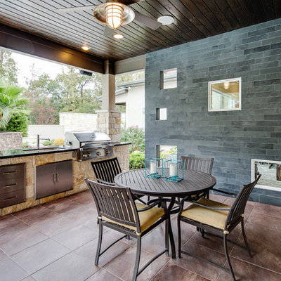 Mid-sized elegant backyard tile patio photo in Houston with a roof extension