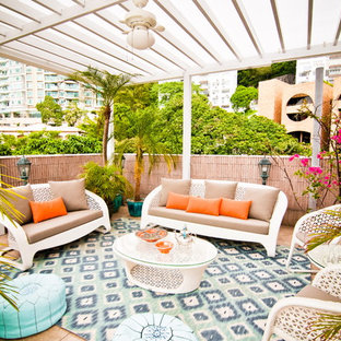 Inspiration for a tropical patio remodel in Nashville with a pergola