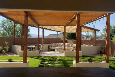Example of a minimalist backyard patio design with a fire pit and a pergola