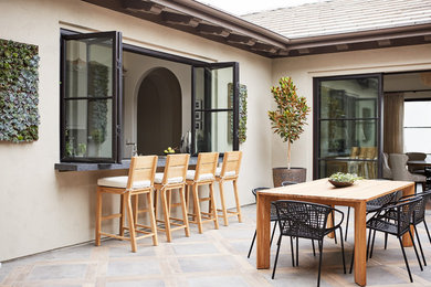 Example of a mid-sized tuscan courtyard patio design in San Francisco with a roof extension