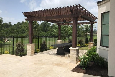 Inspiration for a large mediterranean backyard decomposed granite patio kitchen remodel in Houston with a roof extension