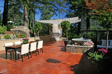 Photo of a large contemporary back patio in San Francisco with a fire feature and concrete slabs.