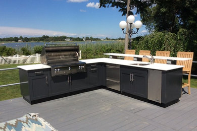 Large minimalist backyard patio kitchen photo in New York with decking and no cover