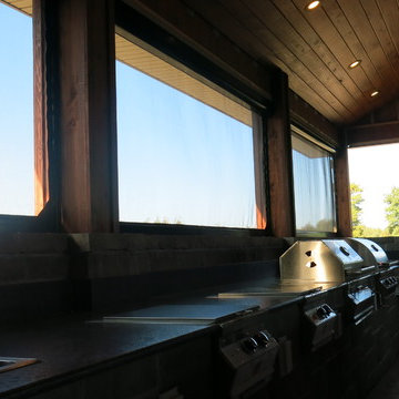 Motorized Retractable Screens In Upscale Hunting Lodge Outdoor Kitchen/Porch