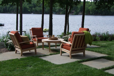 Inspiration for a large timeless backyard stone patio remodel in Boston with no cover