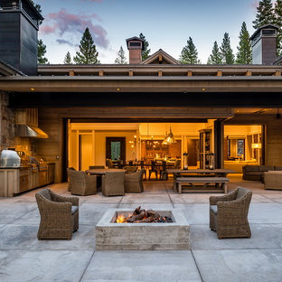 Example of a mountain style backyard concrete patio kitchen design in Sacramento with no cover
