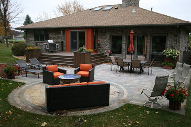 Patio - mid-sized traditional backyard concrete paver patio idea in Other