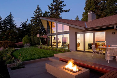 Inspiration for a mid-sized 1950s backyard concrete patio remodel in Portland with a fire pit and no cover