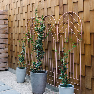 Ispirazione per un patio o portico scandinavo di medie dimensioni e in cortile con un giardino in vaso, piastrelle e nessuna copertura