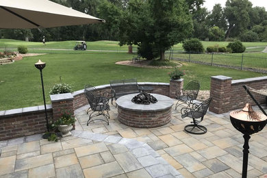 Inspiration for a mid-sized timeless backyard concrete paver patio remodel in Denver with a fire pit and no cover