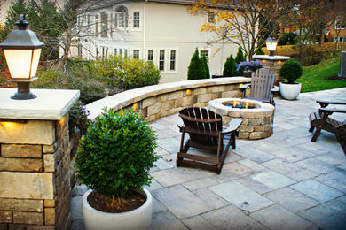 Mid-sized mountain style backyard stone patio photo in Other with a fire pit and no cover