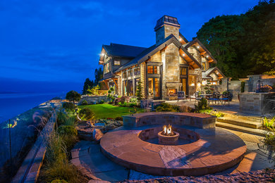 Inspiration for a large rustic patio remodel in Vancouver with a fire pit and no cover
