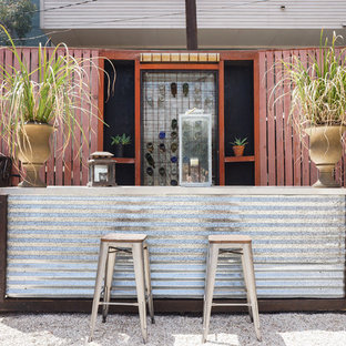 Patio container garden - industrial backyard gravel patio container garden idea in Los Angeles