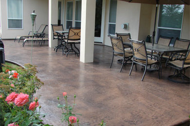 Back patio in Boise with stamped concrete and a roof extension.
