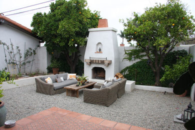 Tuscan backyard gravel patio photo in Los Angeles with a fire pit and no cover