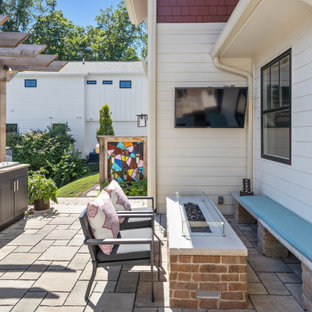 Patio kitchen - country backyard concrete paver patio kitchen idea in Indianapolis with a pergola