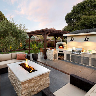 Example of a mid-sized classic side yard patio kitchen design in San Francisco with a pergola