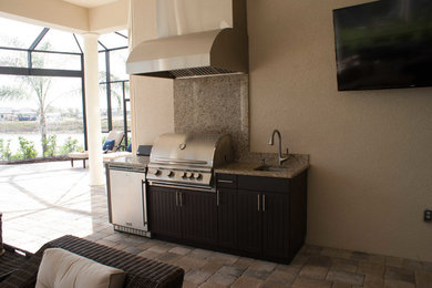 Inspiration for a modern backyard patio kitchen remodel in Miami