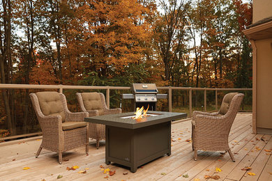 Large elegant backyard patio photo in Toronto with a fire pit, decking and no cover