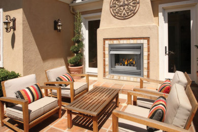 Patio - mid-sized southwestern backyard tile patio idea in Toronto with a fire pit and no cover