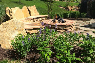 Inspiration for a rustic backyard patio remodel in Other with a fire pit