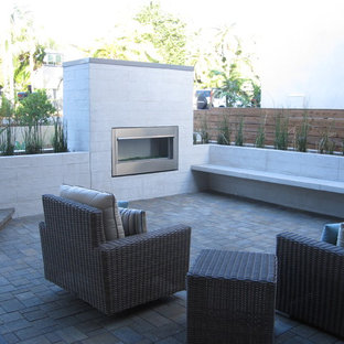Mid-sized minimalist brick patio photo in San Diego with a fire pit and no cover