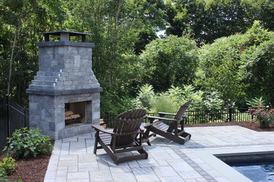 Concrete paver patio photo in Bridgeport with a fire pit