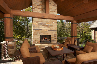 Patio - modern backyard patio idea in Kansas City with a fire pit and a roof extension
