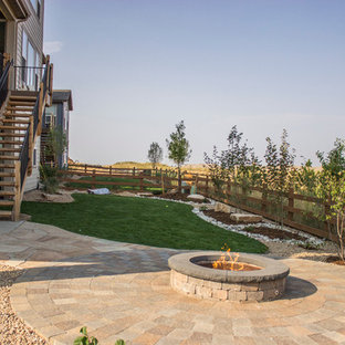 Patio - mid-sized transitional backyard stone patio idea in Denver with a fire pit and no cover
