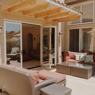 Idee per un patio o portico rustico di medie dimensioni e dietro casa con pavimentazioni in cemento e un tetto a sbalzo