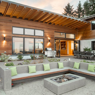 Inspiration for a contemporary backyard concrete patio remodel in Portland with no cover
