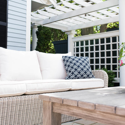 Mid-sized elegant courtyard concrete paver patio photo in Boston with a pergola