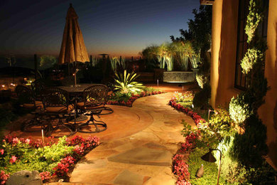 Inspiration for a large transitional backyard stone patio remodel in Orange County