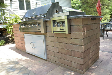 Inspiration for a mid-sized timeless backyard concrete paver patio kitchen remodel in New York