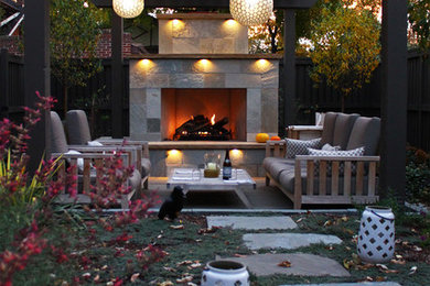 Inspiration for a contemporary back patio in Denver with natural stone paving.