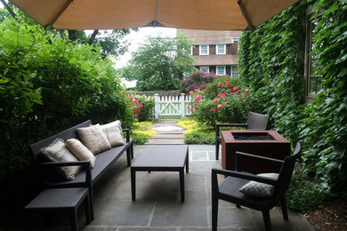Small elegant backyard stone patio photo in New York with a fire pit and no cover